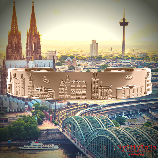 Armreif mit Reliefs bekannter Motive der Stadt Köln in Rotgold
