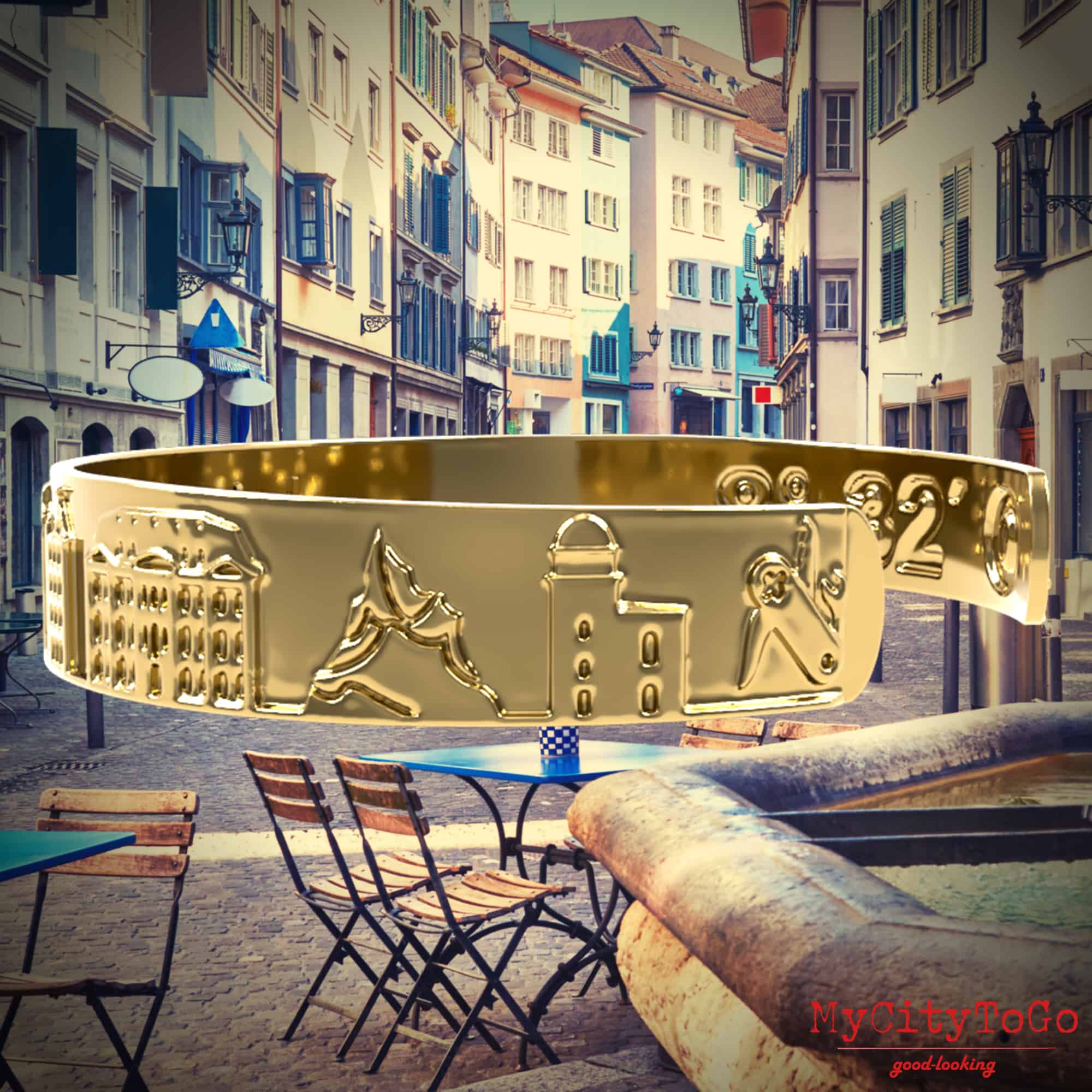 Goldfarbener Armreif mit Reliefs bekannter Motive der Stadt Zürich