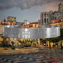 Armreif aus Edelstahl mit Reliefs bekannter Sehenswürdigkeiten von Lissabon. Den Hintergrund bildet eine Ansicht der Stadt Lissabon.