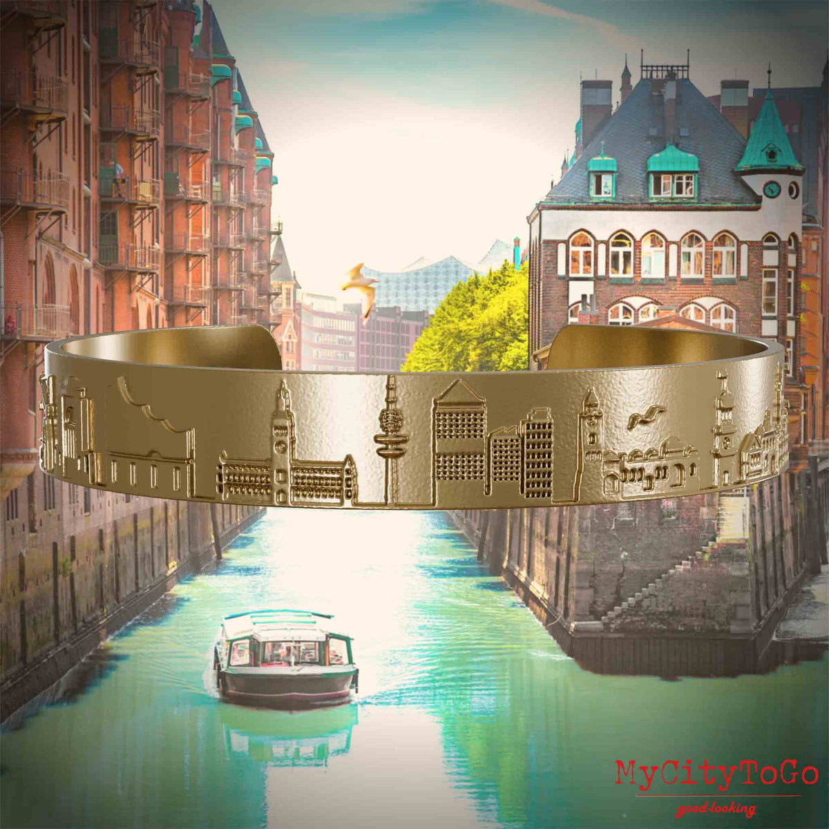 Bangle made of gold-plated stainless steel with reliefs of well-known landmarks in the city of Hamburg. The background features a view of the city of Hamburg.