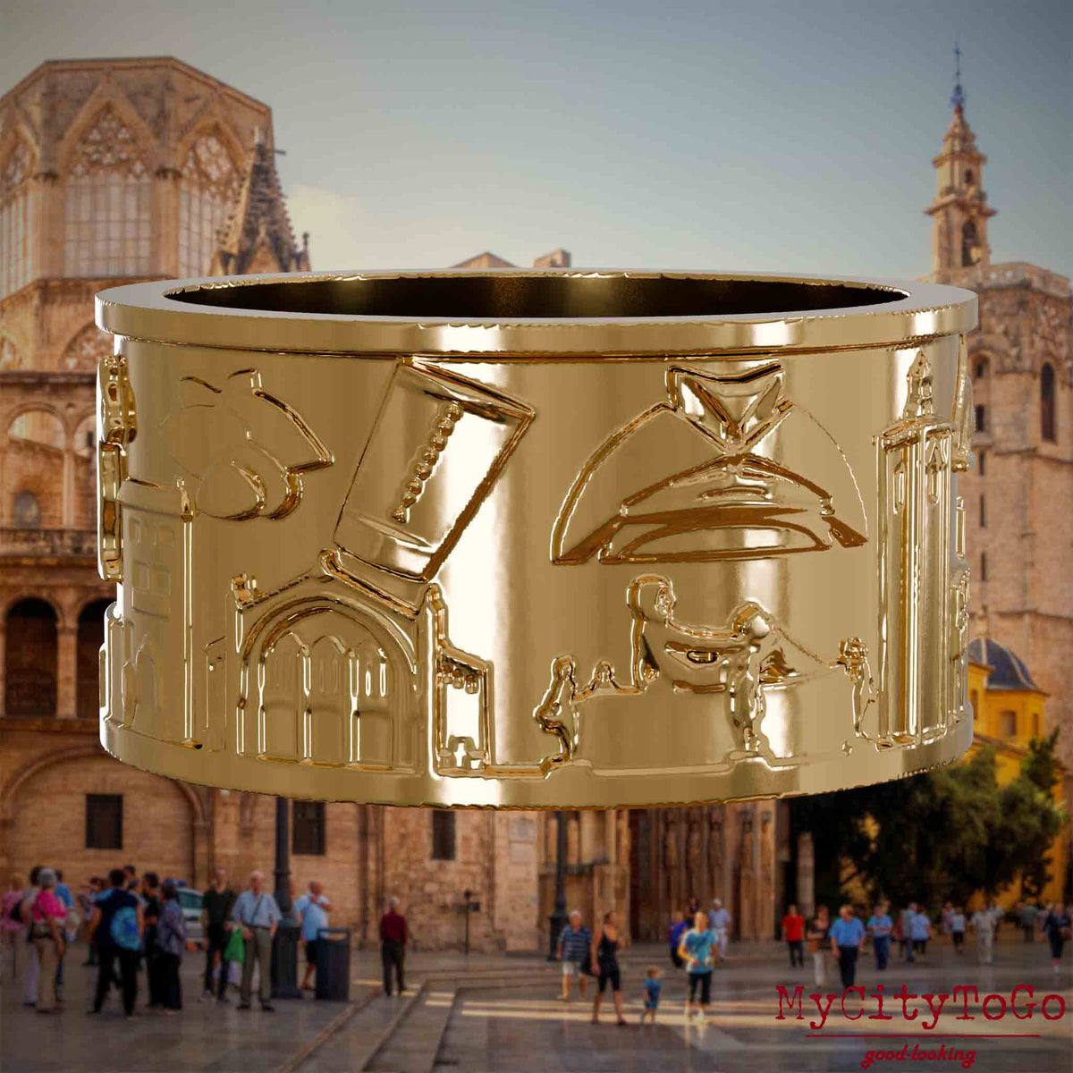 Vergoldeter Ring mit Reliefs bekannter Sehenswürdigkeiten der Stadt Valencia. Den Hintergrund bildet eine Ansicht der Stadt Valencia.