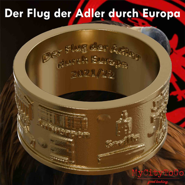 Ring aus vergoldetem Edelstahl mit Reliefs bekannter Sehenswürdigkeiten der Spielorte und Stadien der Frankfurter Europa-League-Saison 2021/22 und einer Gravur mit dem Text "Der Flug der Adler durch Europa 2021/22" auf der Innenseite mit einem Adlerkopf als Hintergrund