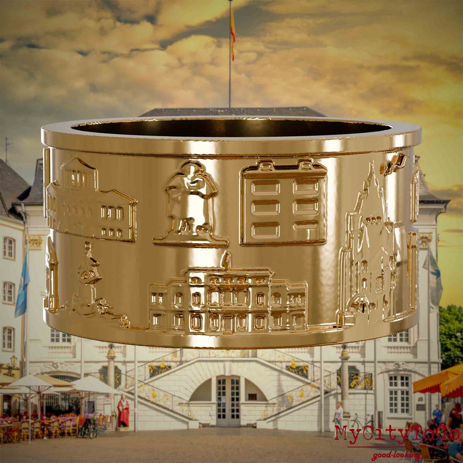 Vergoldeter Ring mit Reliefs bekannter Sehenswürdigkeiten der Stadt Bonn. Den Hintergrund bildet eine Ansicht der Stadt Bonn.