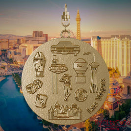 Necklace with swivel clasp and back of a jewelry pendant made of gold-plated stainless steel, featuring reliefs of well-known Las Vegas landmarks. The background shows a view of the city of Las Vegas.