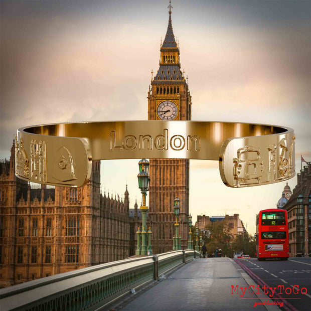 Innenseite eines vergoldeten Amreifs mit Reliefs bekannter Sehenswürdigkeiten der Stadt London und einer Gravur des Stadtnamens. Den Hintergrund bildet eine Ansicht der Stadt London.