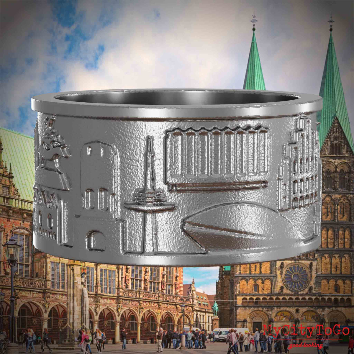 Ring aus Edelstahl mit Reliefs bekannter Sehenswürdigkeiten der Stadt Bremen. Den Hintergrund bildet eine Ansicht der Stadt Bremen.