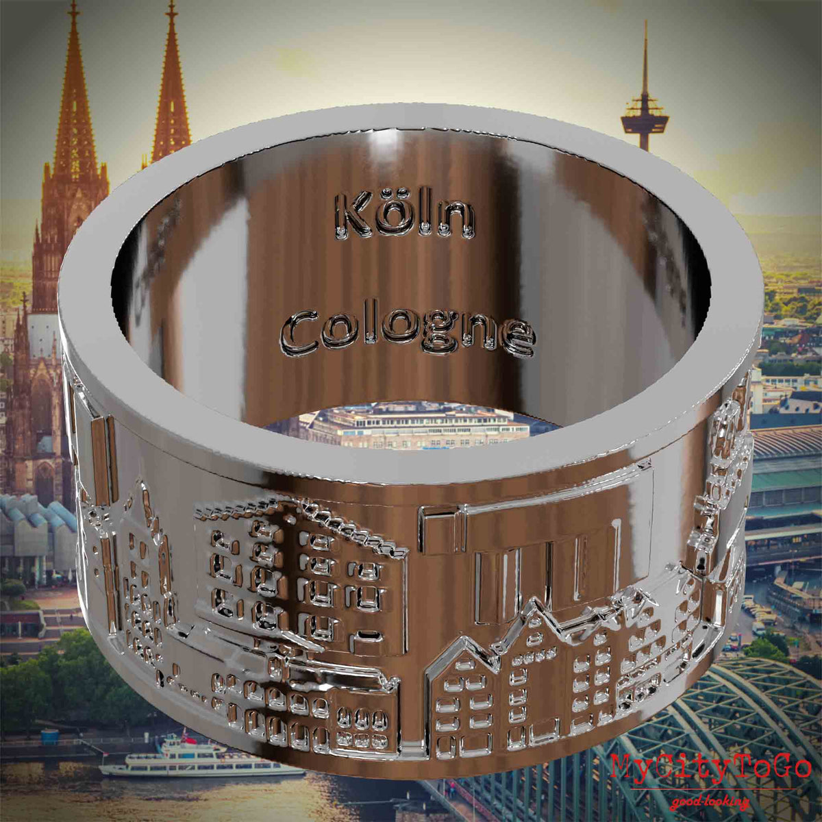 Versilberter Ring mit Reliefs bekannter Sehenswürdigkeiten der Stadt Koeln und einer Gravur des Stadtnamens auf der Innenseite. Den Hintergrund bildet eine Ansicht der Stadt Koeln.