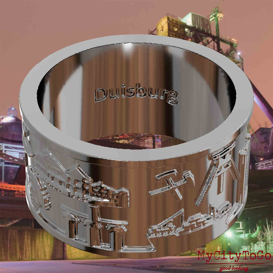 Versilberter Ring mit Reliefs bekannter Sehenswürdigkeiten der Stadt Duisburg und einer Gravur des Stadtnamens auf der Innenseite. Den Hintergrund bildet eine Ansicht der Stadt Duisburg.