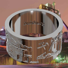 Versilberter Ring mit Reliefs bekannter Sehenswürdigkeiten der Stadt Duisburg und einer Gravur des Stadtnamens auf der Innenseite. Den Hintergrund bildet eine Ansicht der Stadt Duisburg.