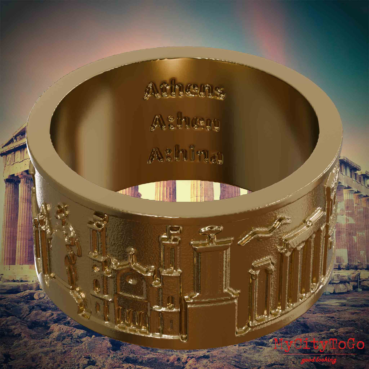 Ring aus vergoldetem Edelstahl mit Reliefs bekannter Sehenswürdigkeiten der Stadt Athen und einer Gravur des Stadtnamens auf der Innenseite. Den Hintergrund bildet eine Ansicht der Stadt Athen.