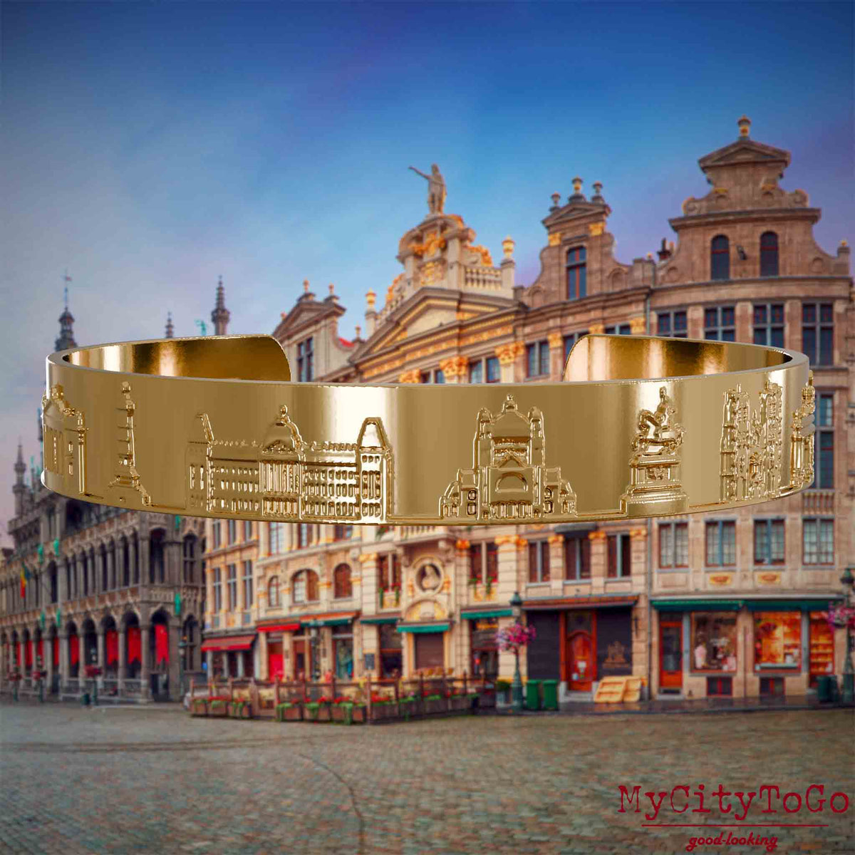 Vergoldeter Armreif mit Reliefs bekannter Sehenswürdigkeiten der Stadt Brüssel. Den Hintergrund bildet eine Ansicht der Stadt Bruessel.