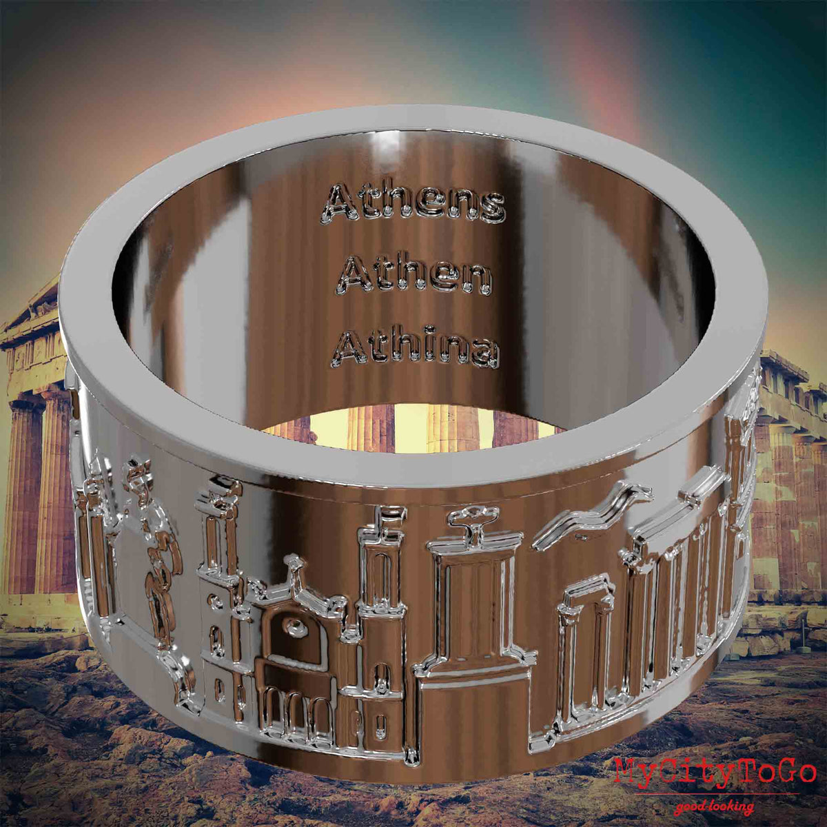 Versilberter Ring mit Reliefs bekannter Sehenswürdigkeiten der Stadt Athen und einer Gravur des Stadtnamens auf der Innenseite. Den Hintergrund bildet eine Ansicht der Stadt Athen.