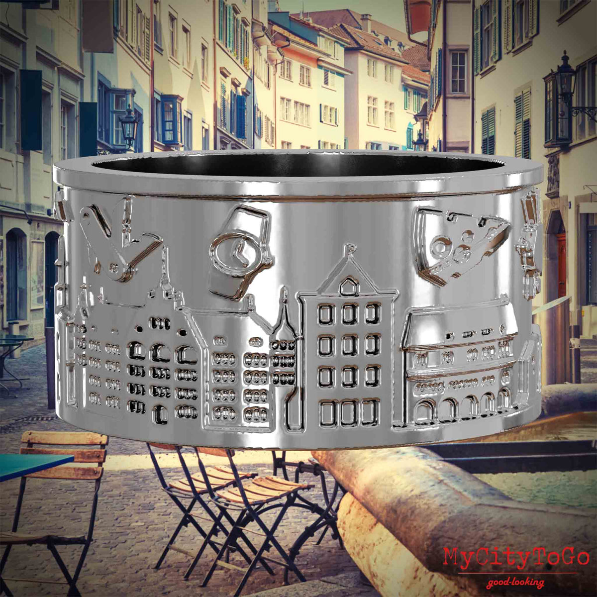 Silberner Ring mit Reliefs bekannter Sehenswürdigkeiten der Stadt Zuerich. Den Hintergrund bildet eine Ansicht der Stadt Zuerich.