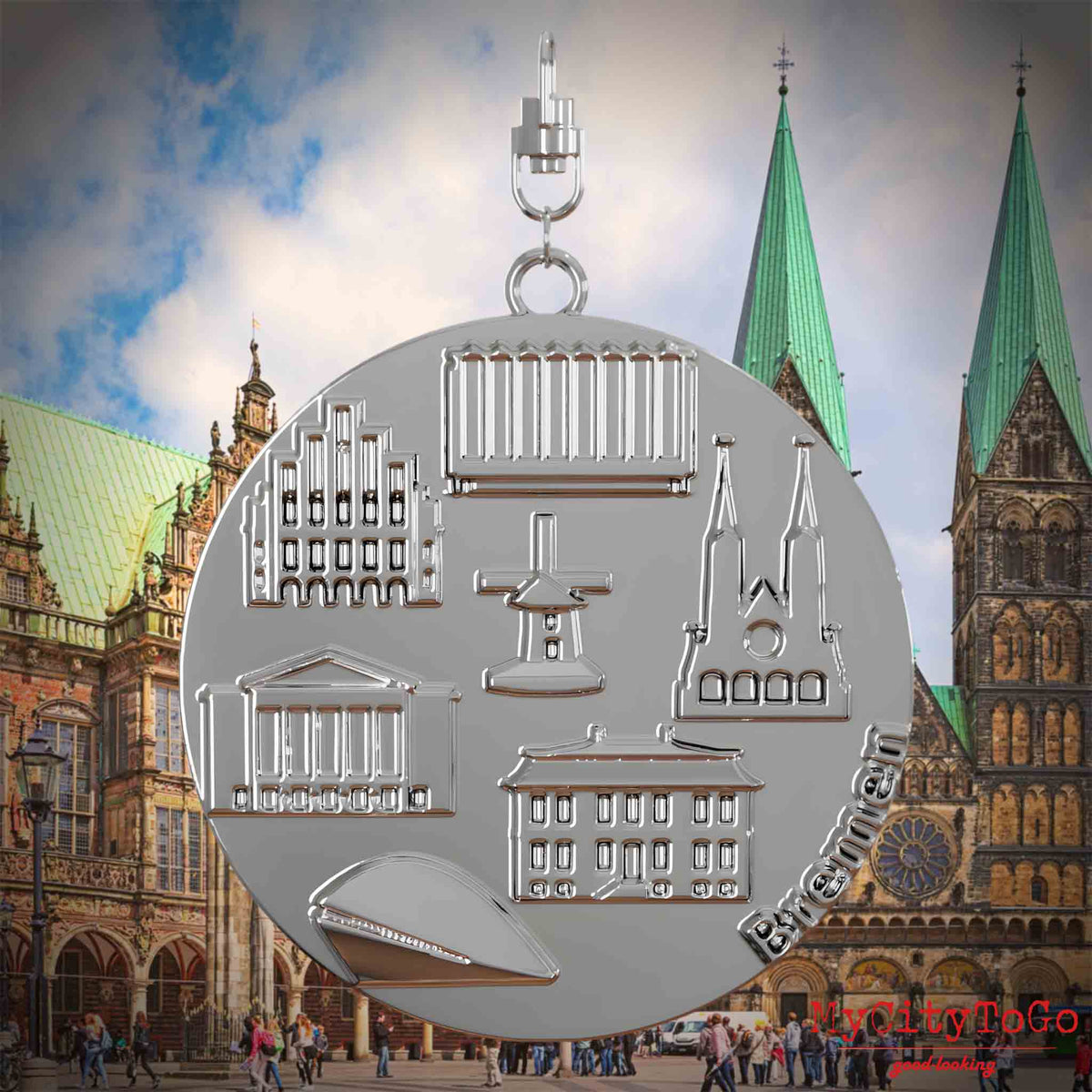 Halskette mit Drehwirbel und Rückseite eines silbernen Schmuckanhängers, auf dem Reliefs bekannter Sehenswürdigkeiten der Stadt Bremen abgebildet sind. Den Hintergrund bildet eine Ansicht der Stadt Bremen.