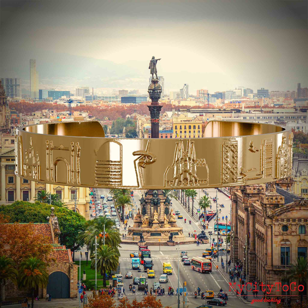 Vergoldeter Armreif mit Reliefs bekannter Sehenswürdigkeiten der Stadt Barcelona. Den Hintergrund bildet eine Ansicht der Stadt Barcelona.