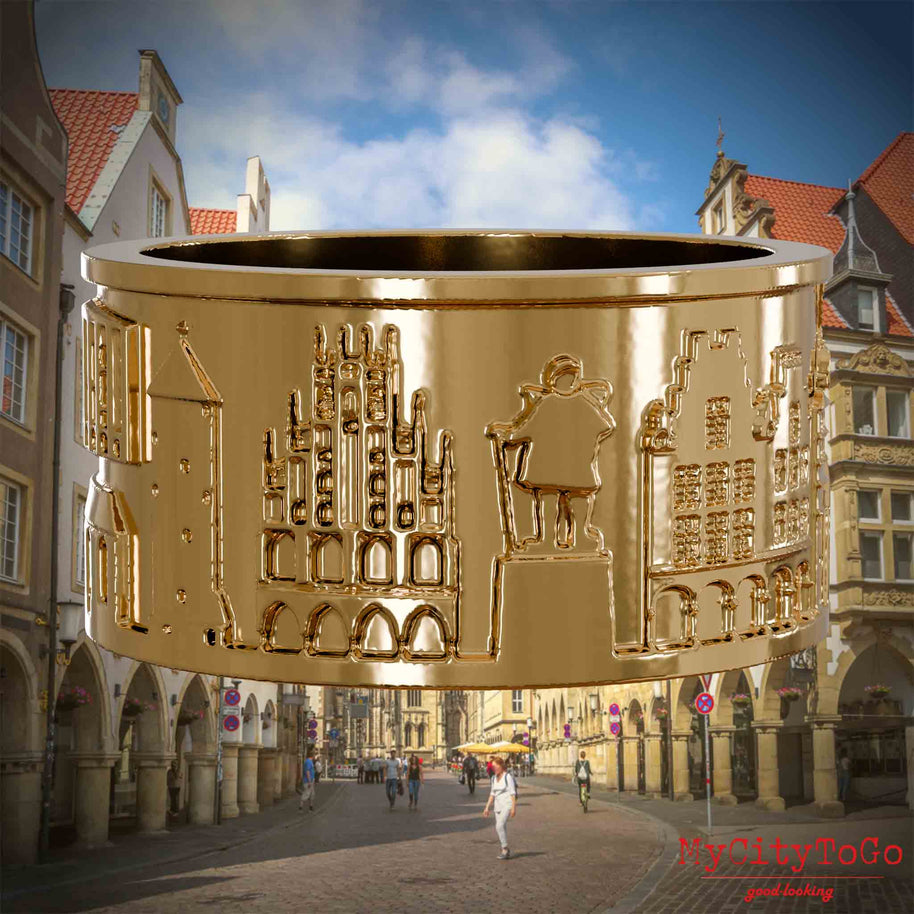 Vergoldeter Ring mit Reliefs bekannter Sehenswürdigkeiten der Stadt Muenster. Den Hintergrund bildet eine Ansicht der Stadt Muenster.