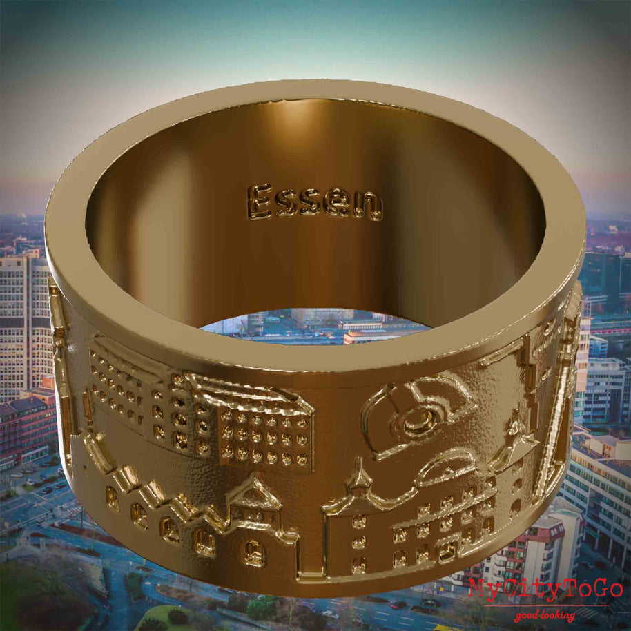 Vergoldeter Ring aus Edelstahl mit Reliefs bekannter Sehenswürdigkeiten der Stadt Essen und einer Gravur des Stadtnamens auf der Innenseite. Den Hintergrund bildet eine Ansicht der Stadt Essen.