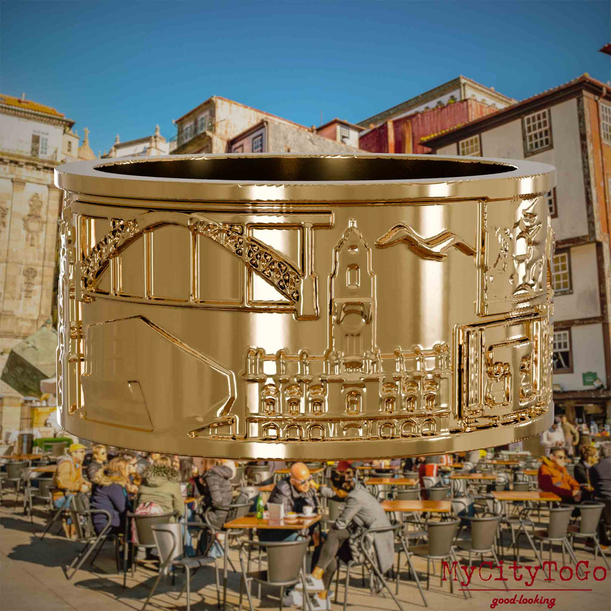 Vergoldeter Ring mit Reliefs bekannter Sehenswürdigkeiten der Stadt Porto. Den Hintergrund bildet eine Ansicht der Stadt Porto.